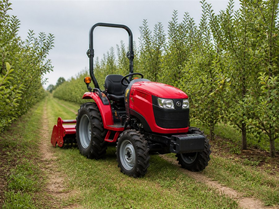 Illustrative compact tractor in an orchard